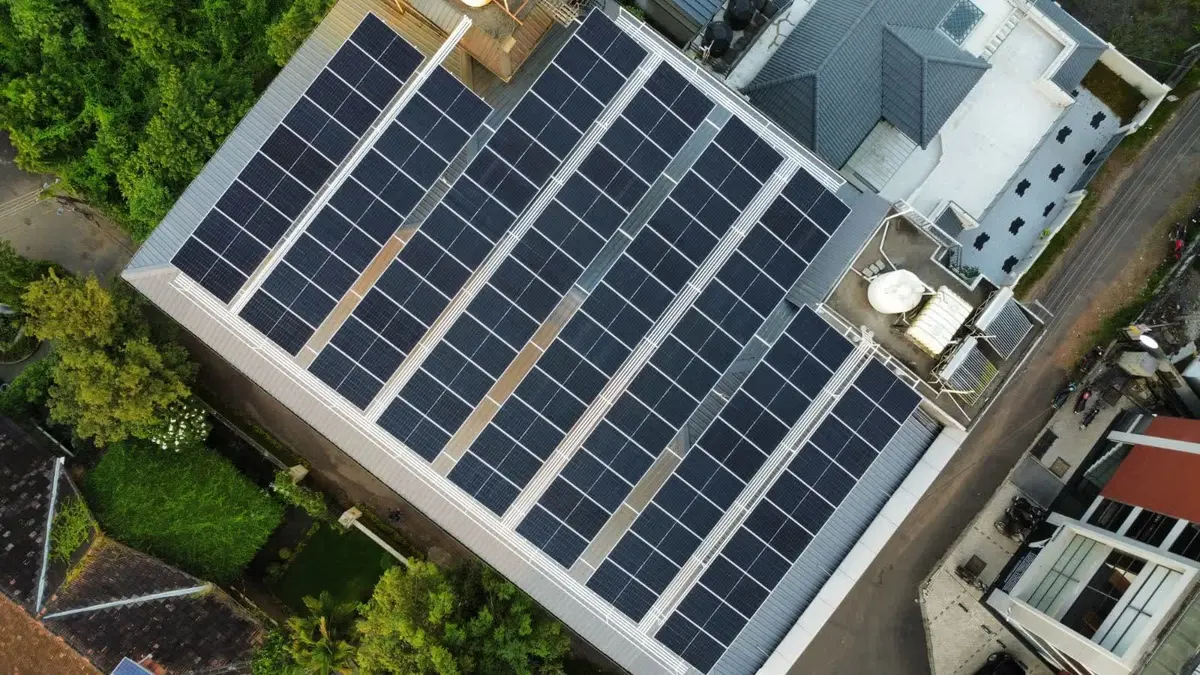 A commercial rooftop solar array installed by Augzet Engineers, panels racked in rows across a warehouse roof in Ernakulam.
