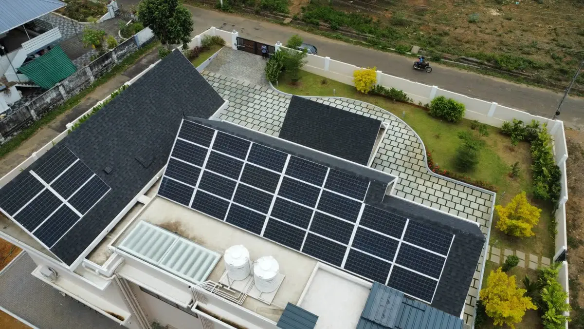 Rooftop solar panels installed on a villa in Kerala by Augzet Engineers.